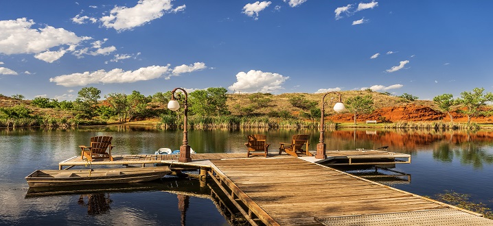 picture of fishing dock on spring fed pond with chairs for guest