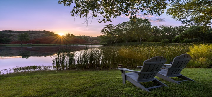 picture of fishing dock on spring fed pond with chairs for guest