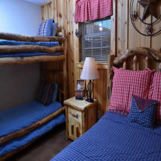 Twin bunk beds and full bed in Americana room at Three Falls Cove