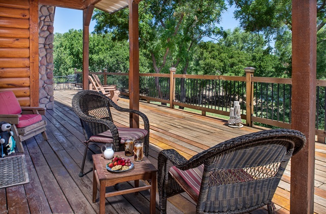 Private patio with outdoor furniture and view of the grounds