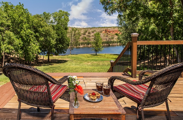 Private patio with outdoor furniture and view of the grounds